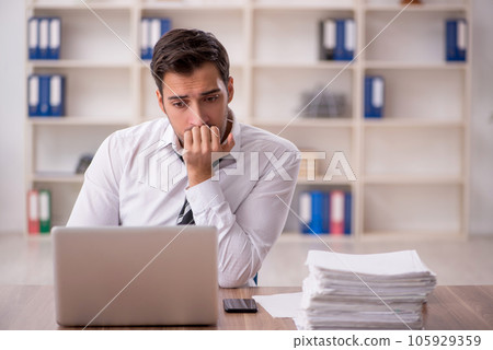 Young male employee working in the office Young male employee working in the office 105929359