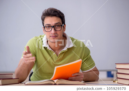 Young male student sitting in the classroom 105929370
