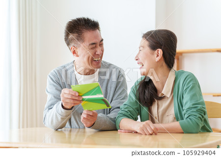 Senior couple smiling at the passbook Senior couple smiling at the passbook 105929404