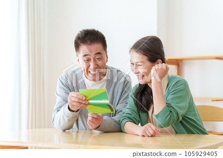 Senior couple smiling at the passbook 105929405