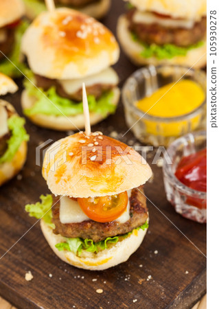 Ready to serve mini hamburgers. Step by step preparation of mini burgers. Homemade mini burgers for children or appetizers. Small hamburgers. Ready to serve mini hamburgers. Step by step preparation of mini burgers. Homemade mini burgers for children or appetizers. Small hamburgers. 105930278