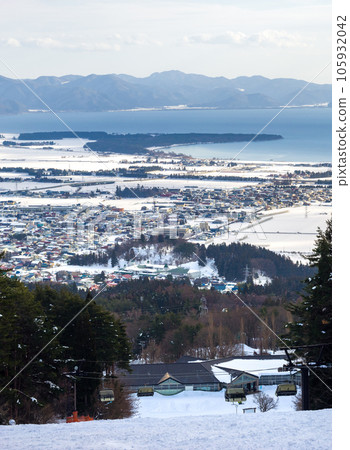 A snowy town and lake seen from a ski resort (Fukushima Prefecture, Inawashiro) A snowy town and lake seen from a ski resort (Fukushima Prefecture, Inawashiro) 105932042