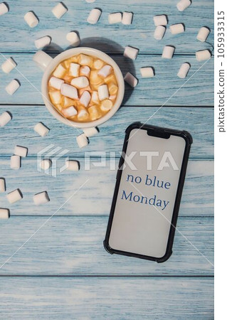 NO BLUE MONDAY concept text on mobile phone screen with white cup of coffee and marshmallows on wooden background. Reminder of The most depressing day of the year in January. Day commit suicide and NO BLUE MONDAY concept text on mobile phone screen with white cup of coffee and marshmallows on wooden background. Reminder of The most depressing day of the year in January. Day commit suicide and 105933315