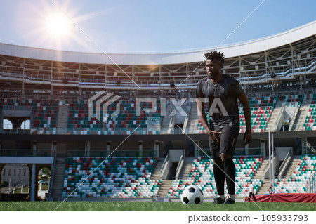 African American soccer player during match inside large stadium African American soccer player during match inside large stadium 105933793