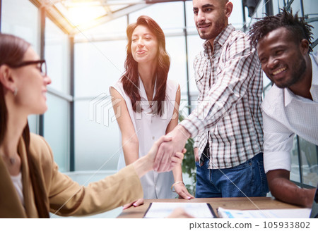 Manager shaking the hand of a female applicant 105933802
