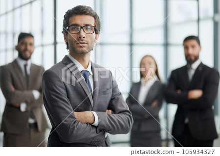 Line of serious multiethnic business man and women looking at camera. Line of serious multiethnic business man and women looking at camera. 105934327