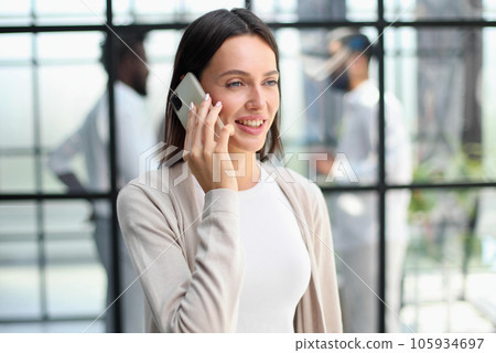Businesswoman with phone in modern office 105934697