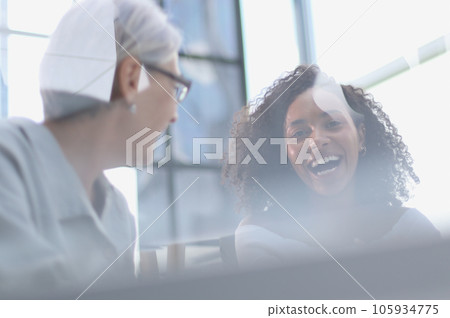 Female colleagues of different nationalities and ages met in the office hall Female colleagues of different nationalities and ages met in the office hall 105934775