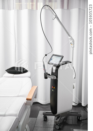 Modern cosmetology equipment for skincare rejuvenation treatment and salon chair in cosmetologist cabinet. Radiofrequency microneedling device for collagen induction therapy in beauty clinic. 105935723