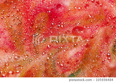Red soap bubbles foam background. Foam of bath bomb dissolved in water. Red soap bubbles foam background. Foam of bath bomb dissolved in water. 105936484