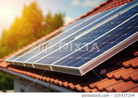 Close up of a new building with solar panels on the roof. Sustainable and clean energy at home. 105937294