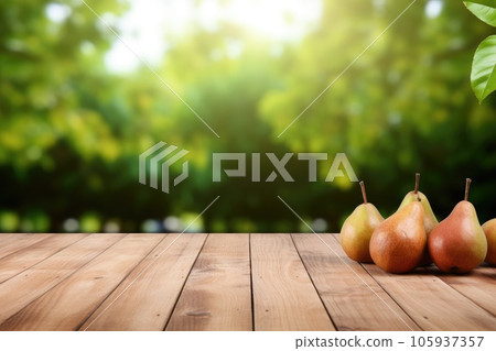 Wooden table top on blurred background of orchard with pears 105937357