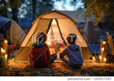 Rear view of children enjoying camping Rear view of children enjoying camping 105937385