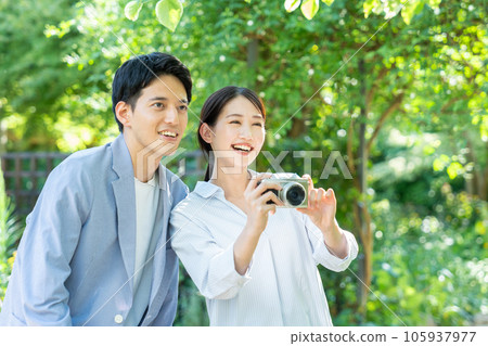 young couple taking pictures young couple taking pictures 105937977