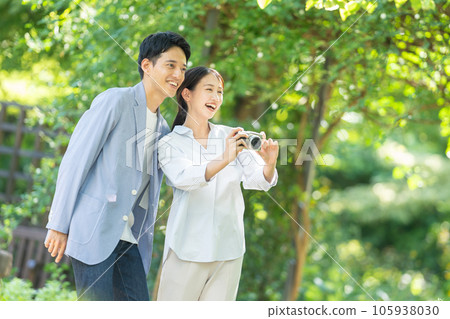 young couple holding a camera young couple holding a camera 105938030