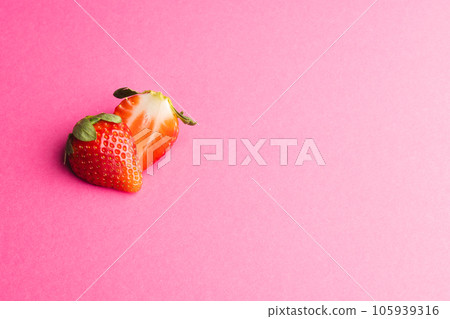 Close up of halved strawberry and copy space on pink background Close up of halved strawberry and copy space on pink background 105939316