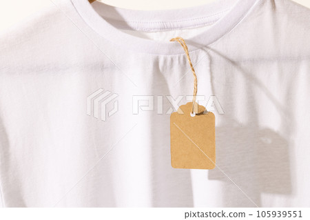 White t shirt with tag with copy space on white background White t shirt with tag with copy space on white background 105939551