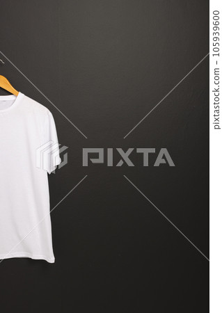 White t shirt on hanger and copy space on black background White t shirt on hanger and copy space on black background 105939600