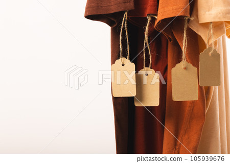 Four t shirts with tags and copy space on white background Four t shirts with tags and copy space on white background 105939676