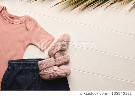 Flat lay of pink baby grow, shorts and pink booties with copy space on white background Flat lay of pink baby grow, shorts and pink booties with copy space on white background 105940151
