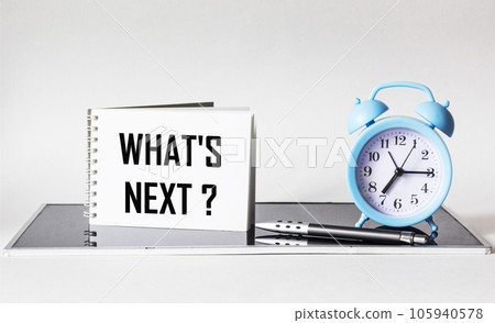 Question What's next written on a notebook next to a clock and a pen on a white  105940578