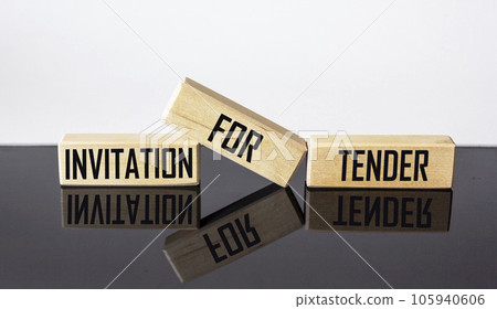 Wooden blocks with the text INVITATION FOR TENDER on a black and white background. 105940606