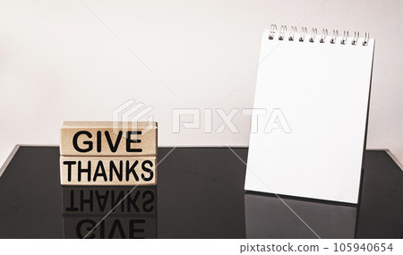 give thanks - text on wooden blocks with reflection on black mirrored background . 105940654
