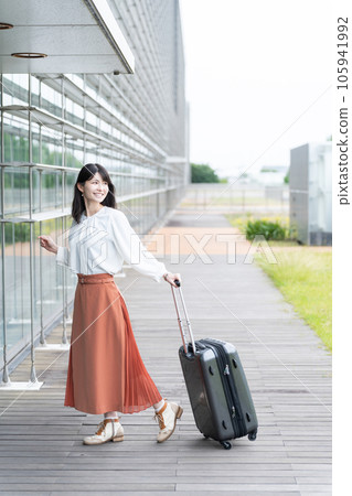 A woman with a carry case (travel/airport) A woman with a carry case (travel/airport) 105941992