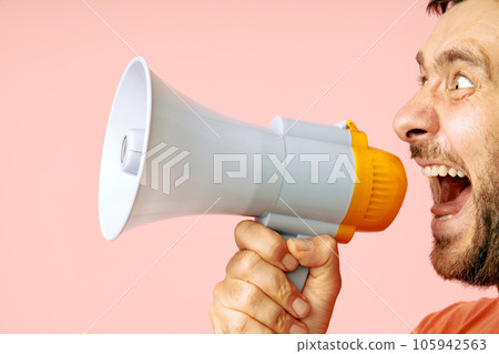 Funny man screaming in megaphone with copy space Funny man screaming in megaphone with copy space 105942563