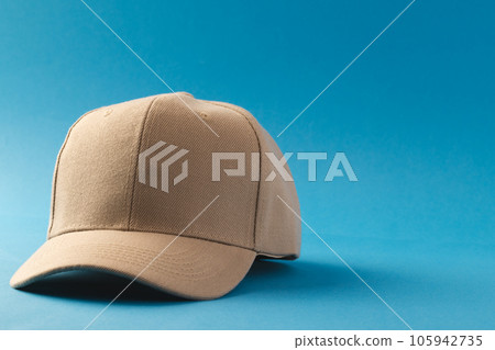 Cream baseball cap and copy space on blue background 105942735