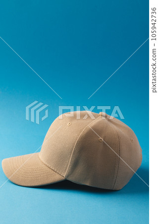 Cream baseball cap and copy space on blue background Cream baseball cap and copy space on blue background 105942736