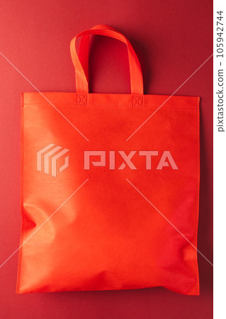 Close up of red canvas bag with copy space on red background Close up of red canvas bag with copy space on red background 105942744