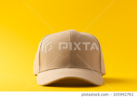 Cream baseball cap and copy space on yellow background 105942761
