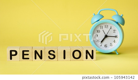 The word PENSION on wooden cubes. There is an alarm clock on a yellow background. Time is money. The word PENSION on wooden cubes. There is an alarm clock on a yellow background. Time is money. 105943142