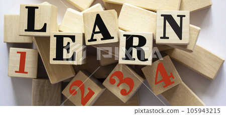 The word learn and 1 2 3 4 written on wooden cubes and a white background. 105943215