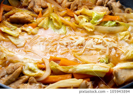 A cooking scene of making cheese dakgalbi (Korean-style stir-fried chicken and vegetables with cheese) in a frying pan. A cooking scene of making cheese dakgalbi (Korean-style stir-fried chicken and vegetables with cheese) in a frying pan. 105943894