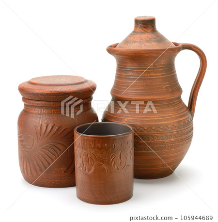 Large earthenware jug, pot and cups isolated on white Large earthenware jug, pot and cups isolated on white 105944689