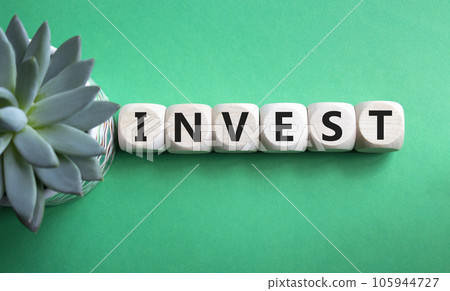 Invest symbol. Wooden blocks with word Invest. Beautiful green background with succulent plant. Business and Invest concept. Copy space. Invest symbol. Wooden blocks with word Invest. Beautiful green background with succulent plant. Business and Invest concept. Copy space. 105944727