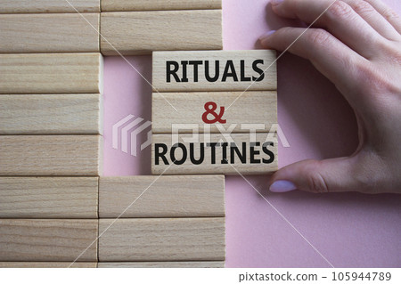 Rituals and Routines symbol. Concept words Rituals and Routines on wooden blocks. Doctor hand. Beautiful pink background. Psychological social mindfullness concept. Copy space. Rituals and Routines symbol. Concept words Rituals and Routines on wooden blocks. Doctor hand. Beautiful pink background. Psychological social mindfullness concept. Copy space. 105944789