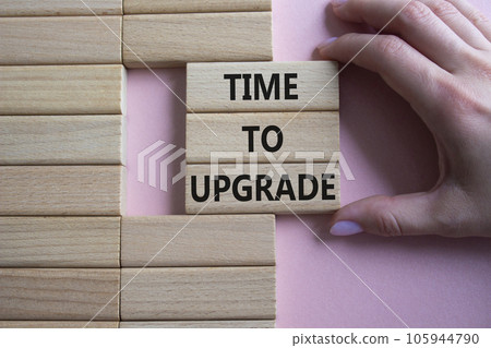 Time to Upgrade symbol. Concept words Time to Upgrade on wooden blocks. Businessman hand. Beautiful pink background. Business and Time to Upgrade concept. Copy space. Time to Upgrade symbol. Concept words Time to Upgrade on wooden blocks. Businessman hand. Beautiful pink background. Business and Time to Upgrade concept. Copy space. 105944790