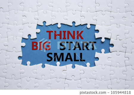 Think big start small symbol. Concept words Think big start small on white puzzle. Beautiful blue background. Business and Think big start small concept. Copy space 105944818