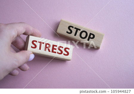 Stop Stress symbol. Concept word Stop Stress on wooden blocks. Businessman hand. Beautiful pink background. Business and Stop Stress concept. Copy space 105944827