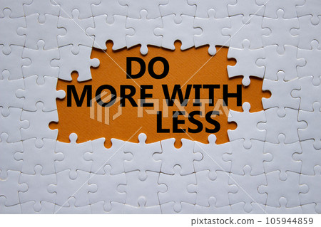 Do more with less symbol. Concept words Do more with less on white puzzle. Beautiful orange background. Business and Do more with less concept. Copy space. 105944859