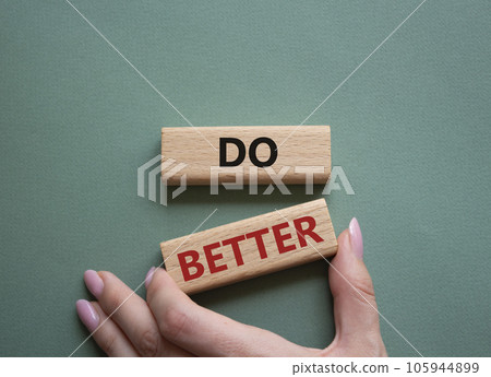 Do better symbol. Wooden blocks with words Do better. Beautiful grey green background. Businessman hand. Business and Do better concept. Copy space. Do better symbol. Wooden blocks with words Do better. Beautiful grey green background. Businessman hand. Business and Do better concept. Copy space. 105944899