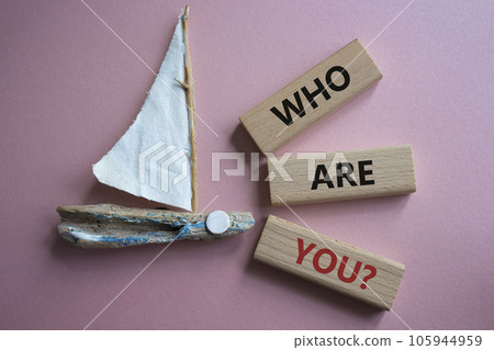 Who are You symbol. Concept words Who are You on wooden blocks. Beautiful pink background with boat. Business and Who are You concept. Copy space. Who are You symbol. Concept words Who are You on wooden blocks. Beautiful pink background with boat. Business and Who are You concept. Copy space. 105944959