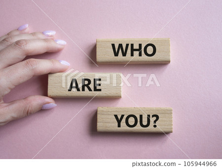 Who are You symbol. Concept words Who are You on wooden blocks. Businessman hand. Beautiful pink background. Business and Who are You concept. Copy space. Who are You symbol. Concept words Who are You on wooden blocks. Businessman hand. Beautiful pink background. Business and Who are You concept. Copy space. 105944966