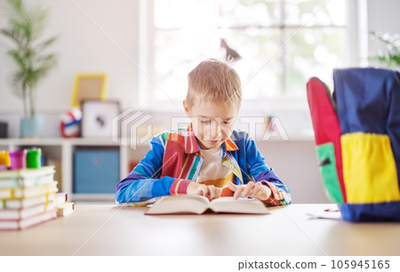 Happy boy smiling and turning pages. 105945165