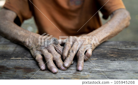 Elderly man holding hands on knees because of disease, health care or elderly concept. Elderly man holding hands on knees because of disease, health care or elderly concept. 105945208