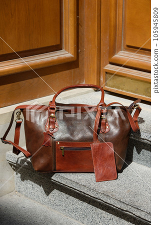 brown female leather bag. street photo brown female leather bag. street photo 105945809
