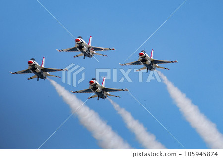 Four USAF Thunderbirds F-16 jets flying in the diamond formation with a blue sky Four USAF Thunderbirds F-16 jets flying in the diamond formation with a blue sky 105945874